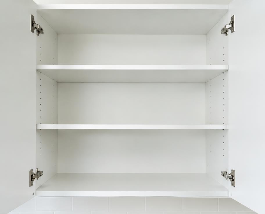 Open, clean, empty white kitchen cupboard