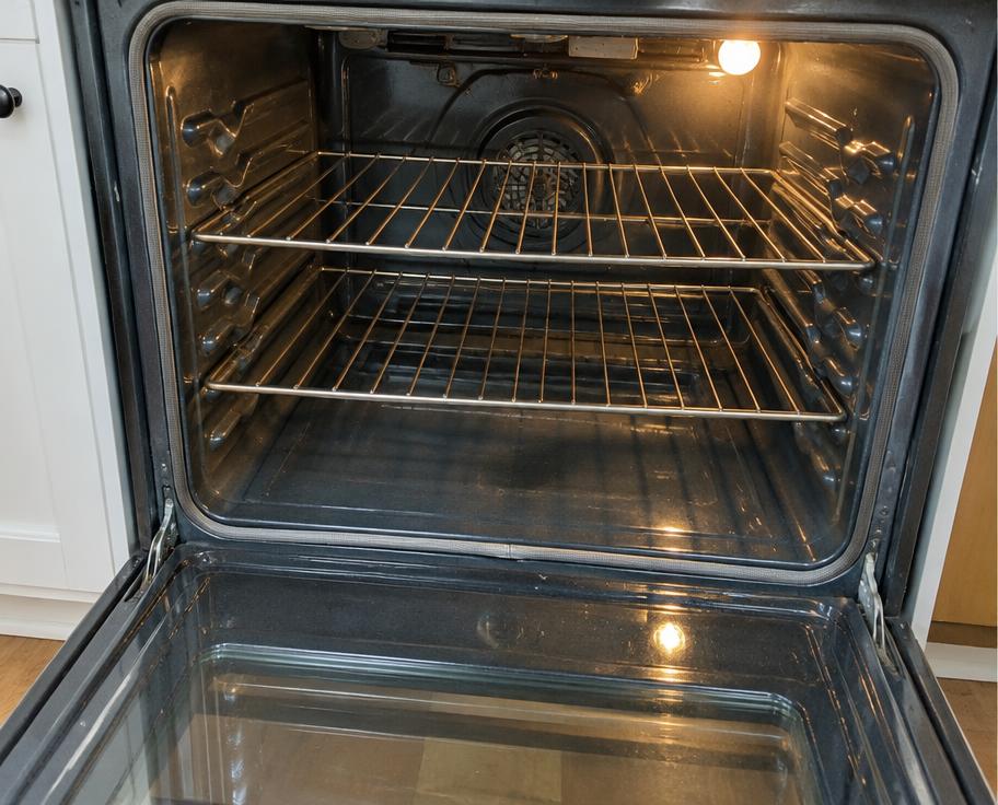 Spotless oven interior with gleaming racks and glass door